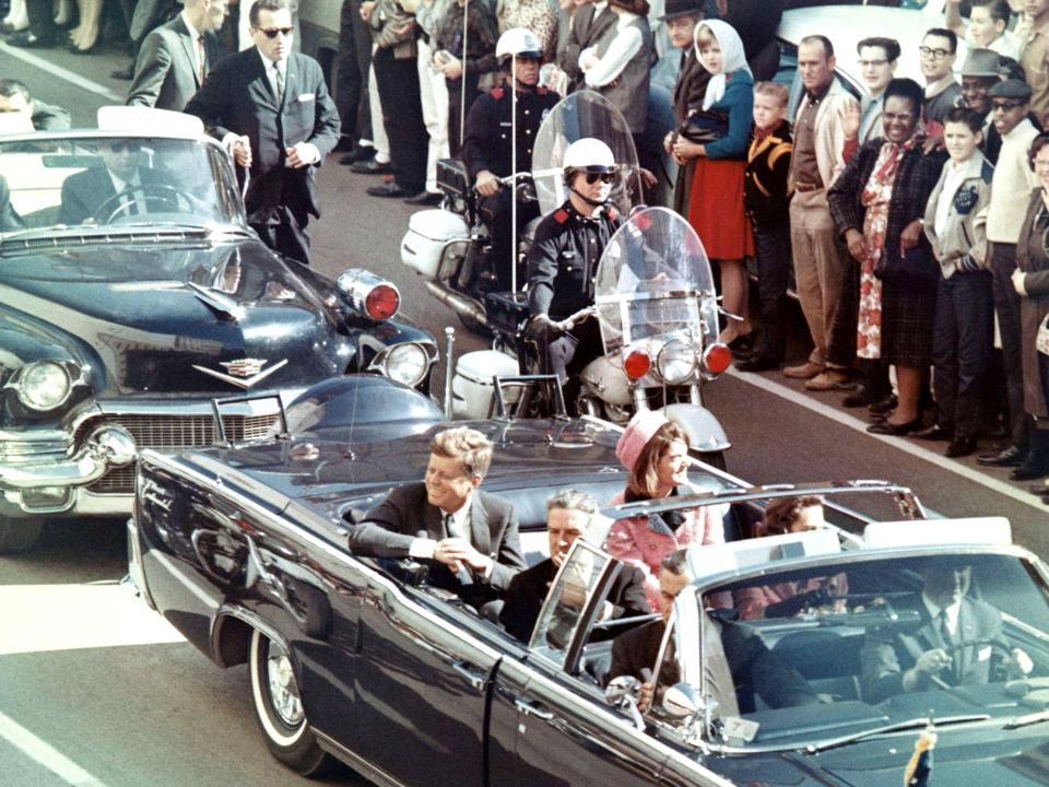 President Kennedy and Jackie Kennedy in a motorcade in Dallas, Texas, minutes before the assassination.