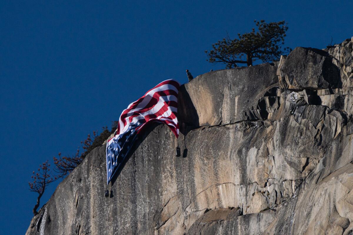 An upside-down American flag hangs from El Capitan in Yosemite National Park.