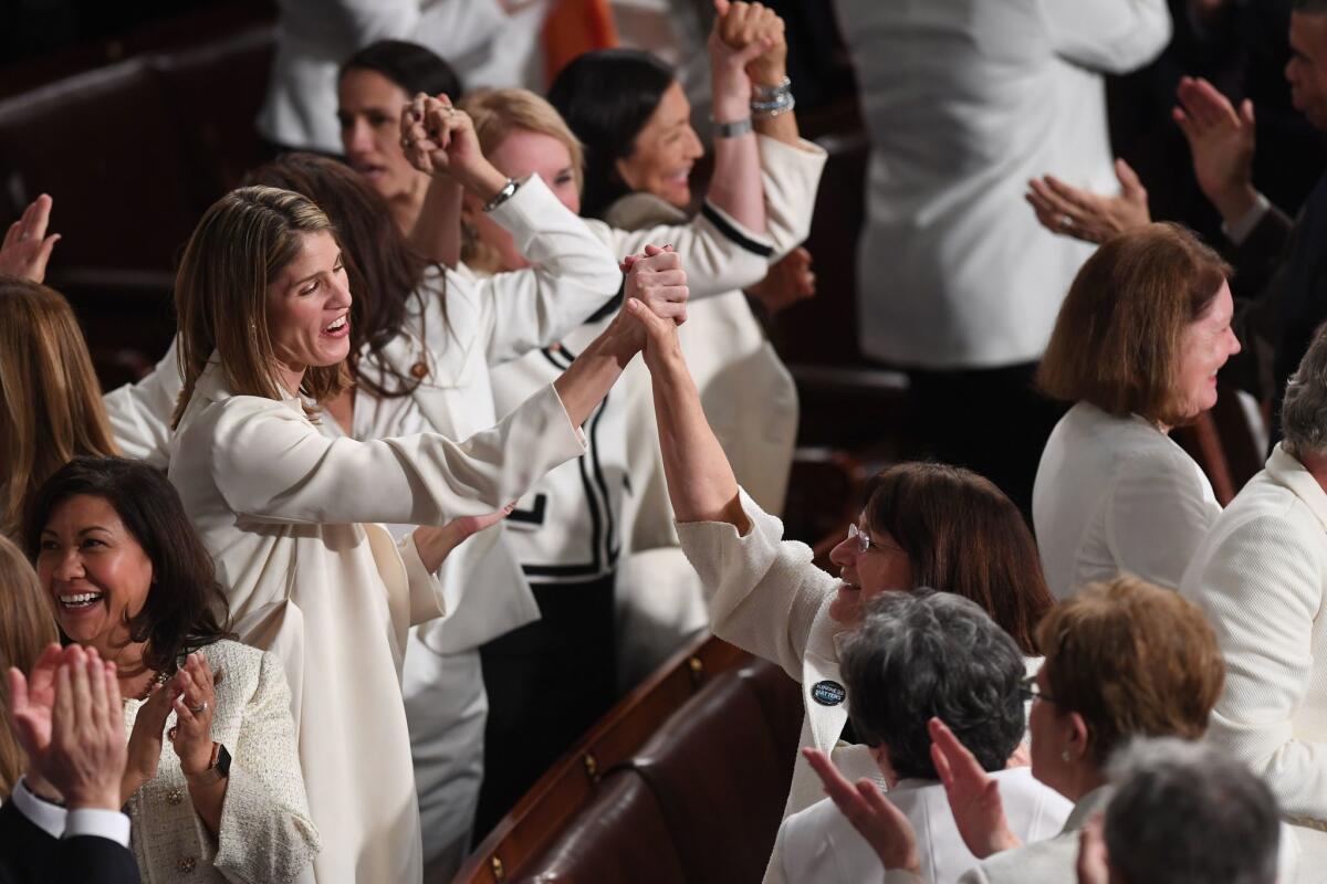 Lawmakers, dressed in white in tribute to the women's suffrage movement, applaud as they attend the State of the Union address at the Capitol on Tuesday.