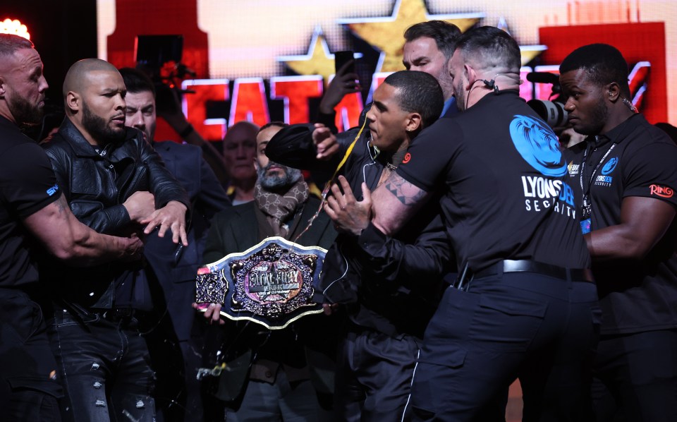 Conor Benn being held back after Chris Eubank Jr. throws an egg.