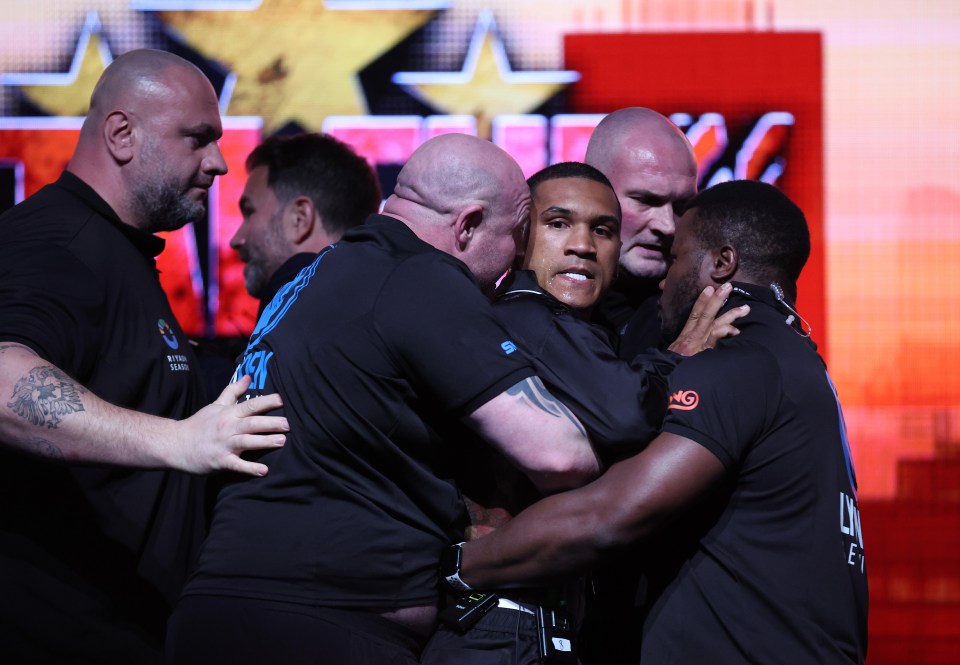 Conor Benn being held back by security at a boxing press conference.