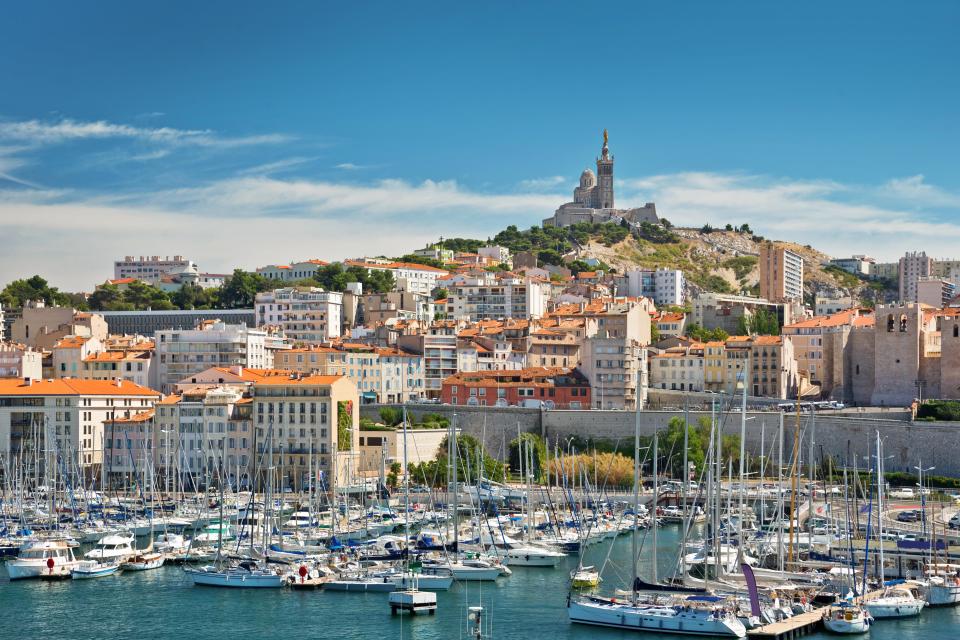 View of the old port of Marseille, France, with boats and the city in the background.