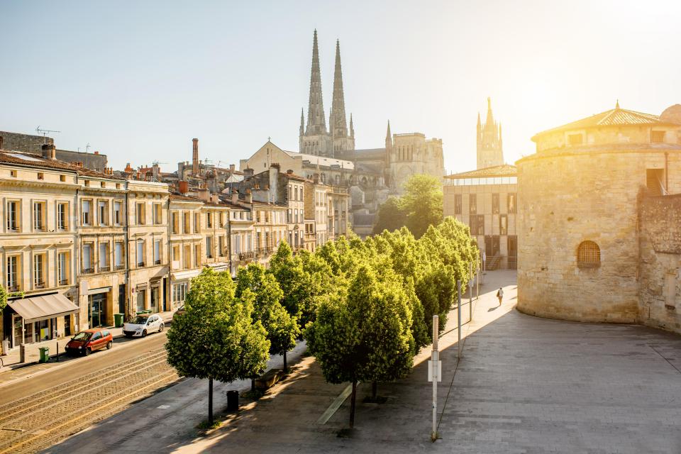 Bordeaux city street scene with cathedral in background.