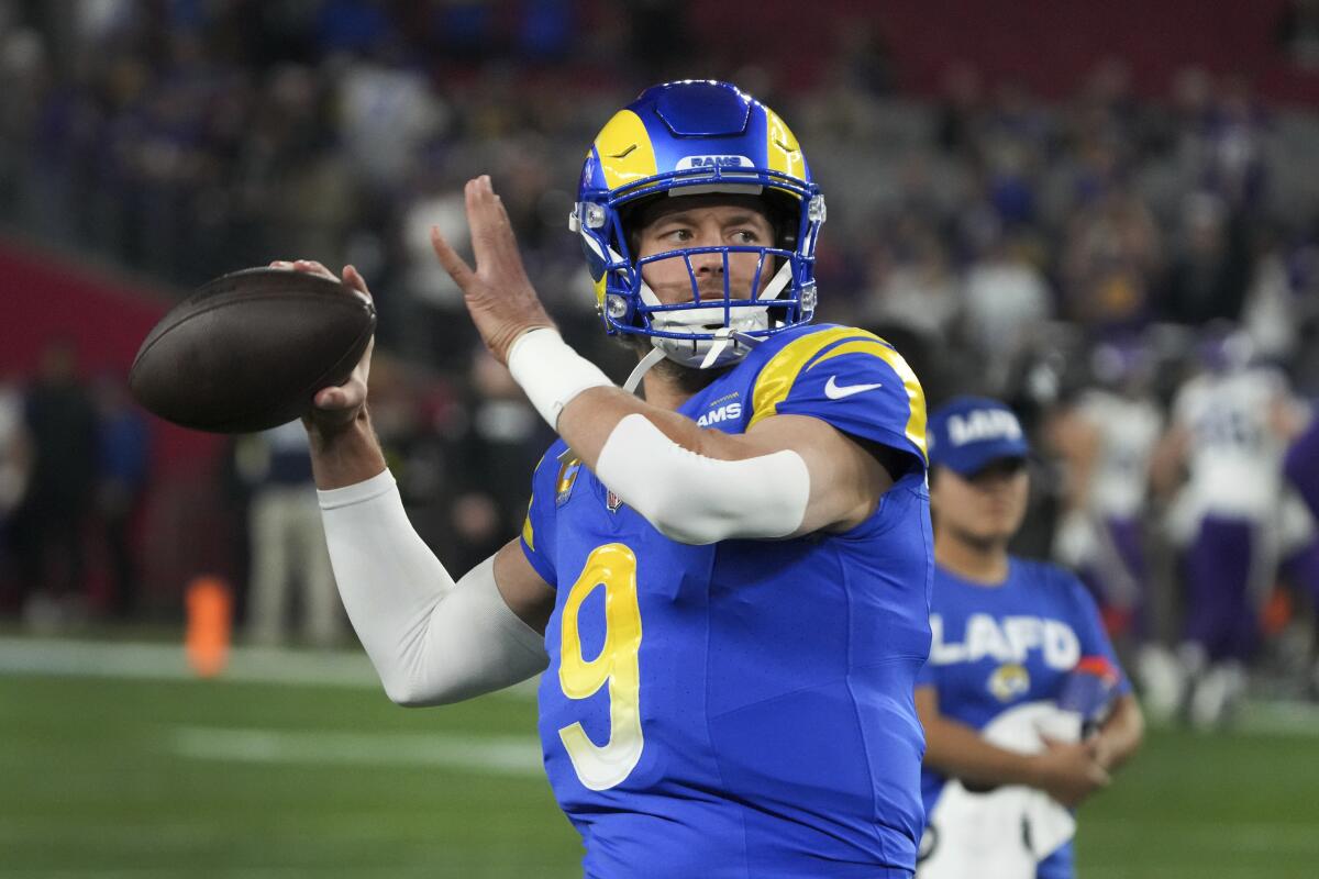 Rams quarterback Matthew Stafford throws before an NFL wild card playoff.