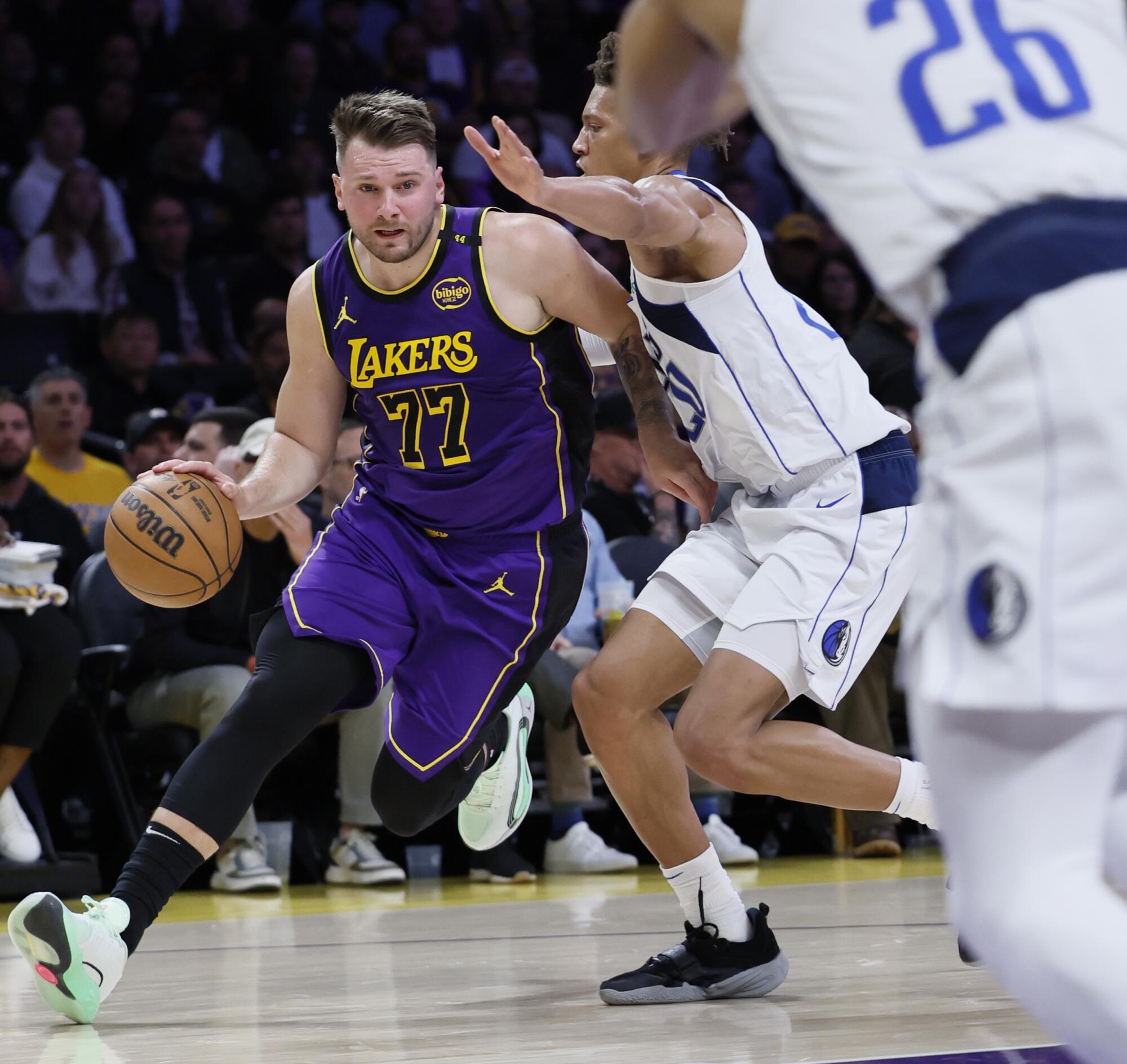 Lakers point guard Luka Doncic drives to the hoop past Dallas Mavericks forward Kessler Edwards.