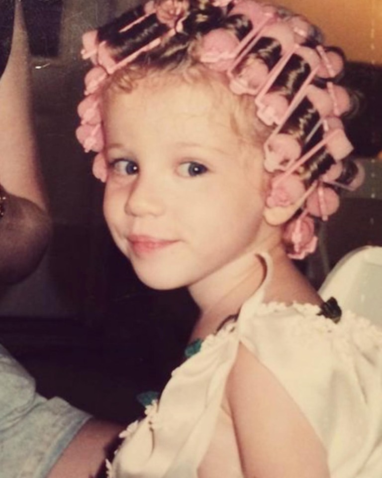 Young Michelle Trachtenberg with hair rollers.