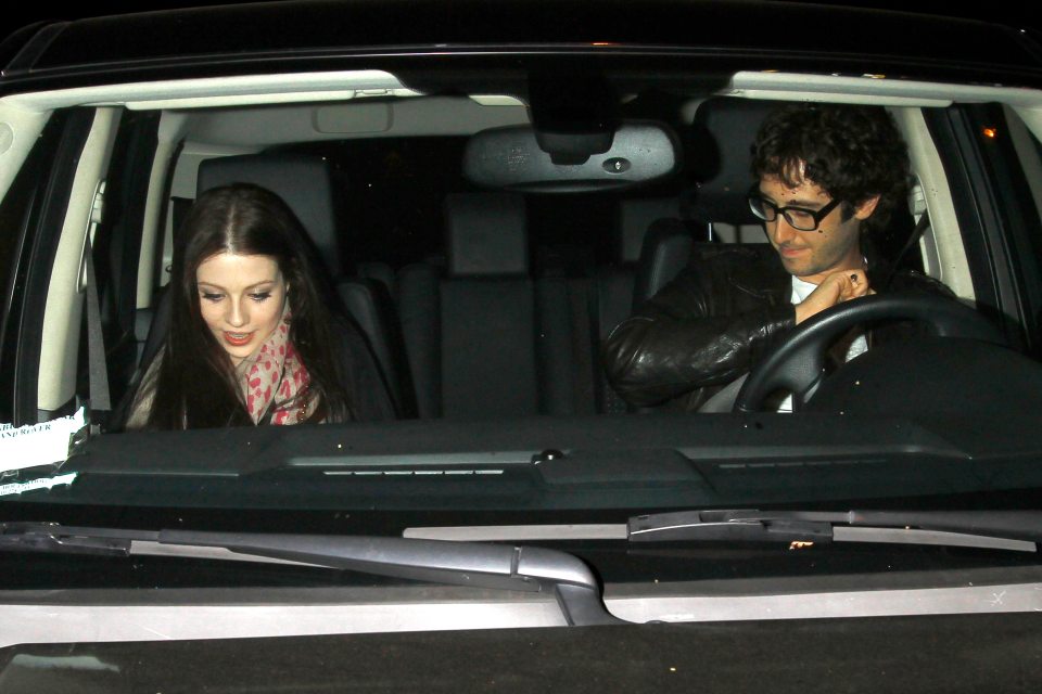 Josh Groban and Michelle Trachtenberg smiling in a car.