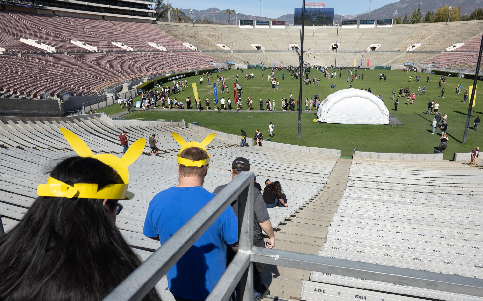 Participants walk to events at the Rose Bowl during the Pokemon Go Tour: Unova.