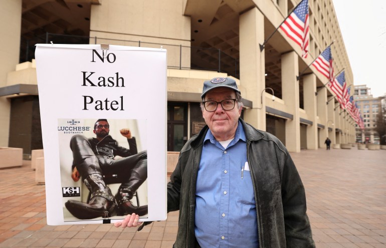 A protester holds up a sign that reads, "No Kash Patel."