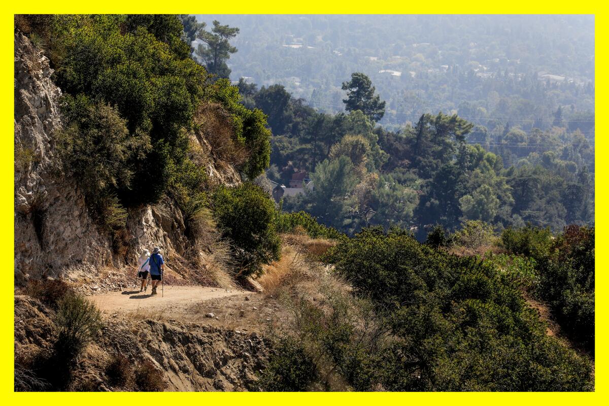 Hikers descend the long, steep Earl Canyon Motorway trail in the Alta Canyada neighborhood of La Cañada Flintridge.