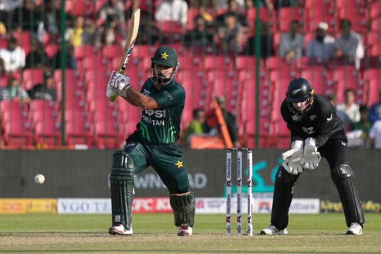 Pakistan's Khushdil Shah, left, plays a shot during the tri-series ODI cricket final match between Pakistan and New Zealand, in Karachi, Pakistan, Friday, Feb. 14, 2025. (AP Photo/Fareed Khan)