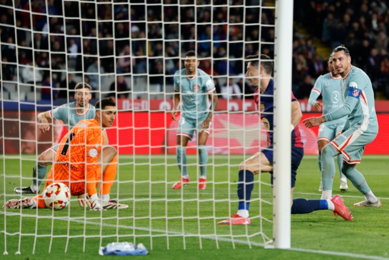 Barcelona's Robert Lewandowski scores during a Spanish Copa del Rey, or King's Cup, the semi-final soccer match between Barcelona and Atletico Madrid in Barcelona, Spain, Wednesday, Feb. 26, 2025. AP Photo/Joan Monfort)