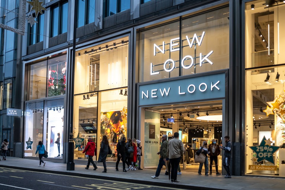 New Look store in London at night with shoppers.