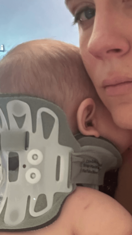 Woman holding baby wearing a neck brace.