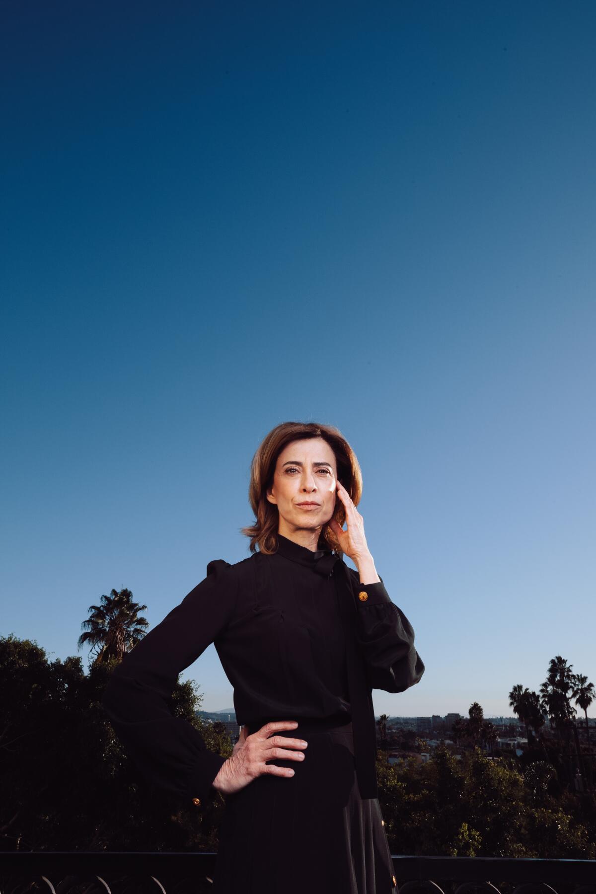 Fernanda Torres of the film "I'm Still Here," poses for a portrait outside at dusk.