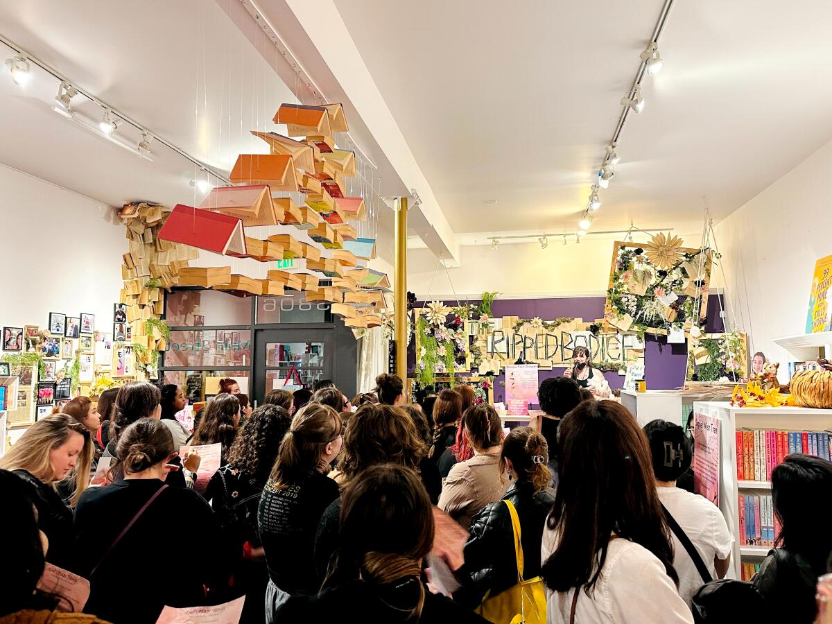 People gather to celebrate inside a bookstore for a midnight launch party.