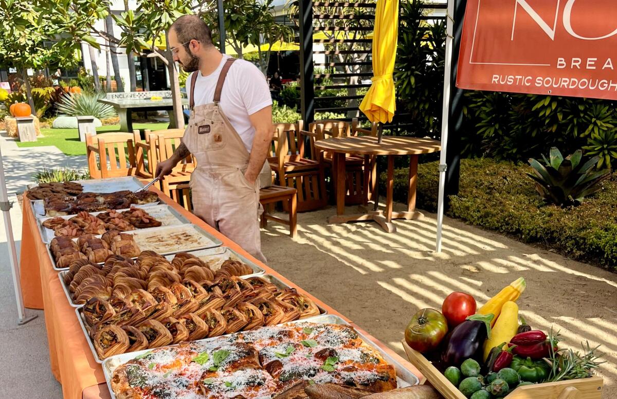 Lee Begim looks over trays of pastries at a pop-up.