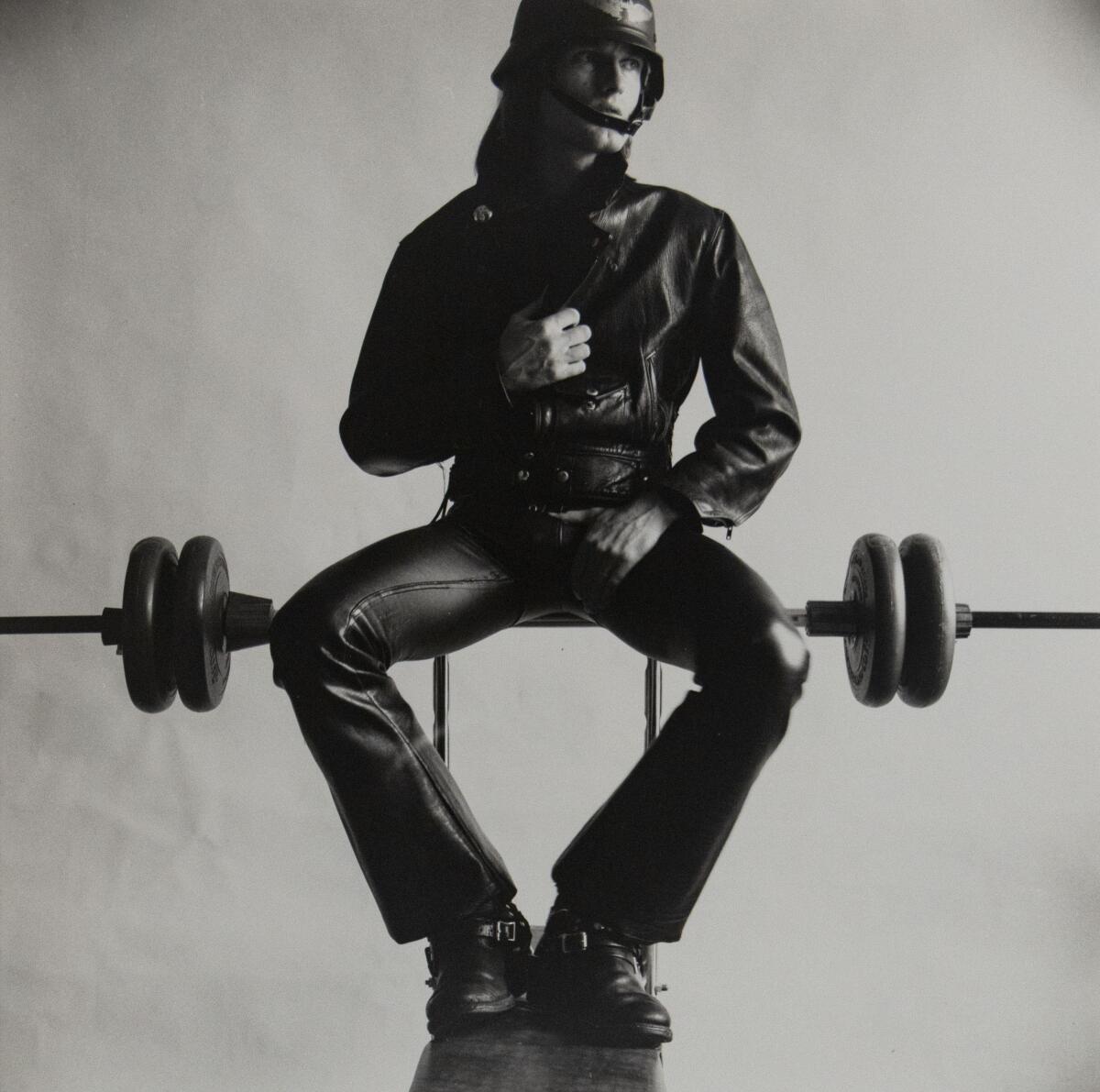 Peter Berlin, "Self Portrait in Black Leather on Weight Bench," on view at Mariposa Gallery.