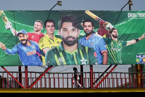 AFP A billboard depicts Indian cricket captain Rohit Sharma (2L) ahead of Champions Trophy in Lahore on February 15, 2025