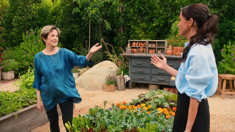 Meghan Markle and Alice Waters in a garden.