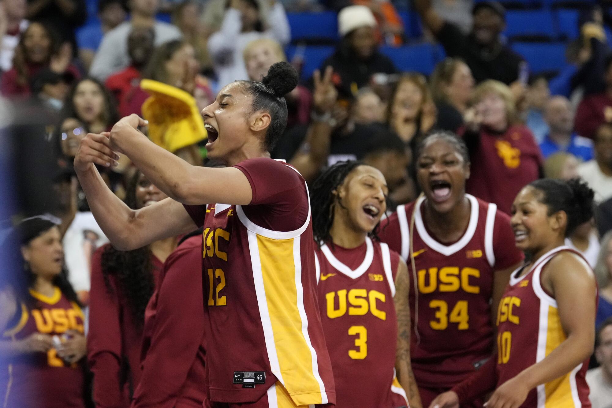 USC guard JuJu Watkins, left, celebrates with teammates during a win over UCLA at Pauley Pavilion on Saturday night.