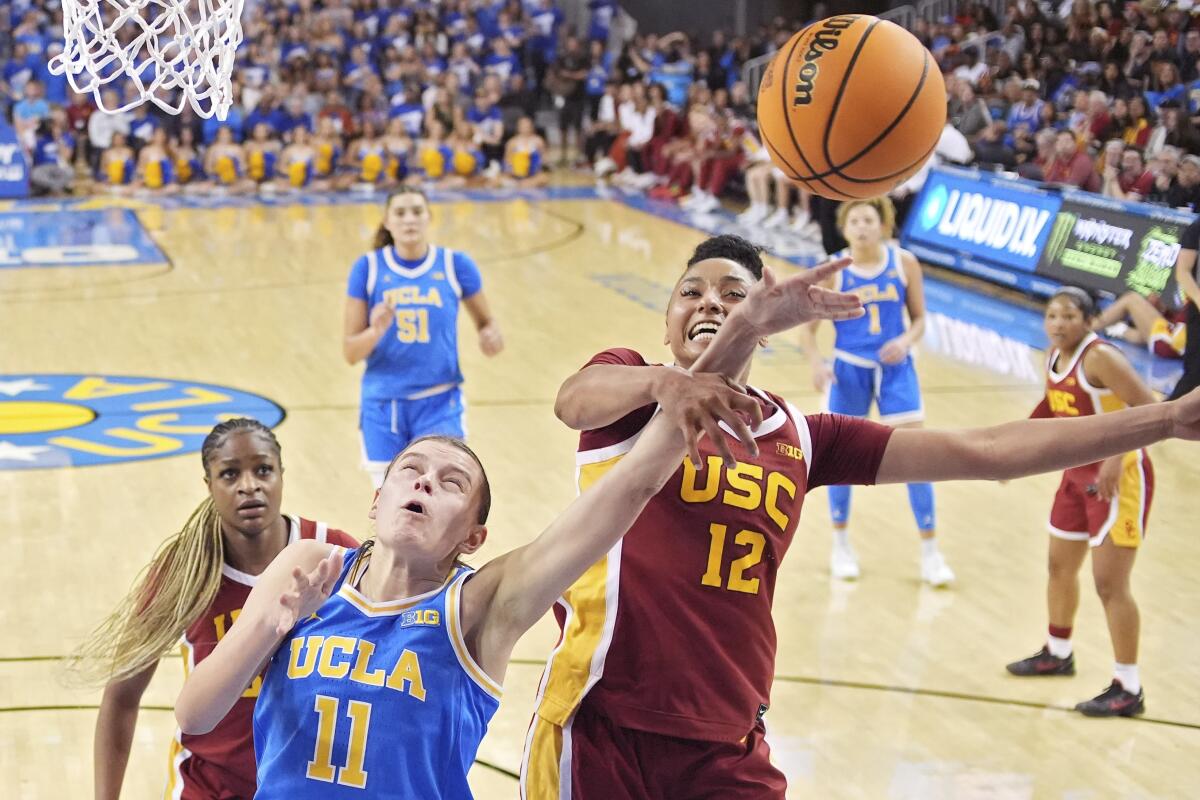 USC guard JuJu Watkins blocks UCLA guard Gabriela Jaquez's shot 