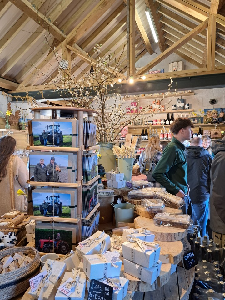 Interior of Diddly Squat Farm Shop with customers browsing and purchasing items.