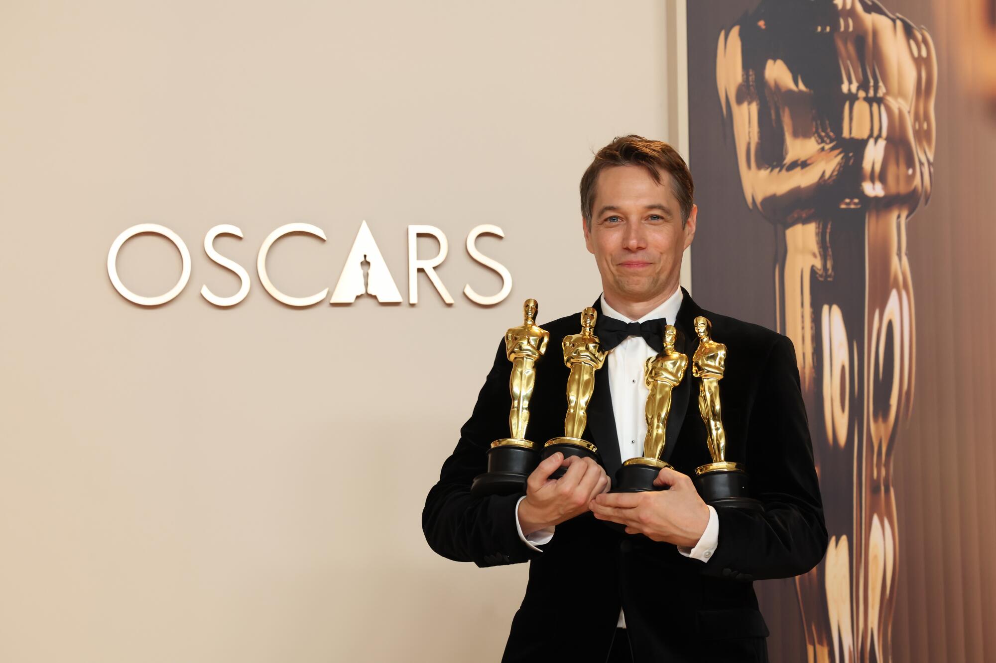 "Anora's" Sean Baker holds his four Oscars.