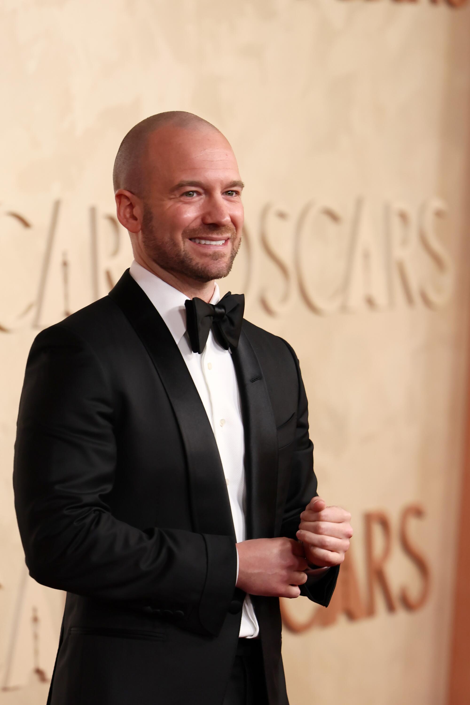 Sean Evans smiles in a tuxedo.