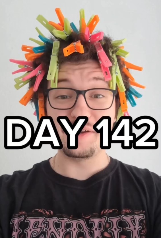 Person with colorful clothespins in their hair; Day 142.