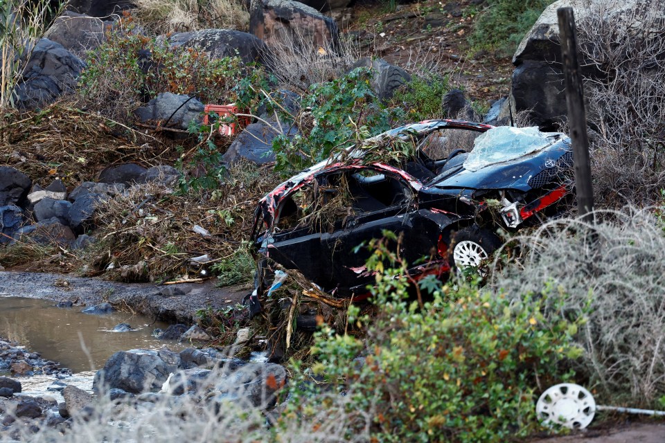 Car damaged by floodwaters and debris.