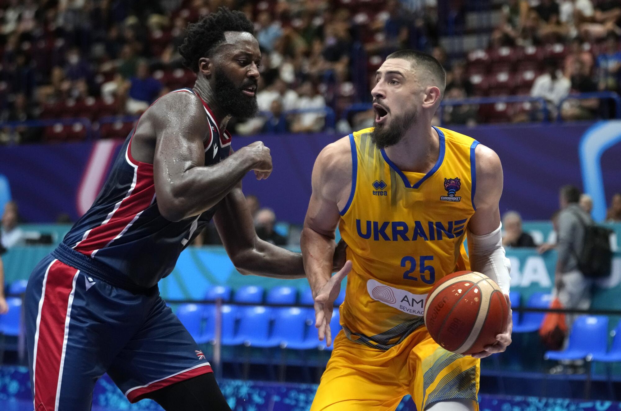 Ukraine's Alex Len dribbles under pressure from Britain's Gabriel Olaseni during a Eurobasket game in 2022.