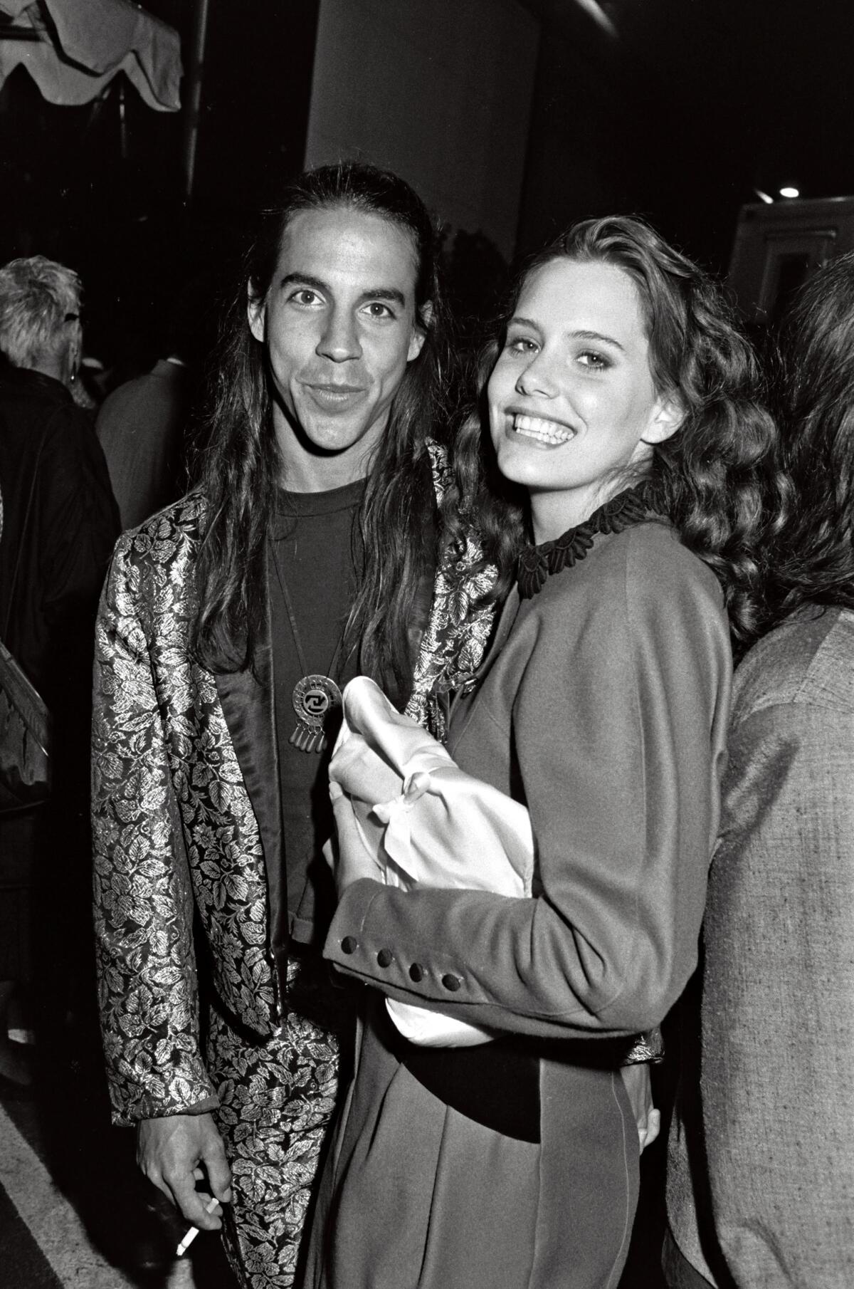 Anthony Kiedis and Ione Skye smile at cameras.