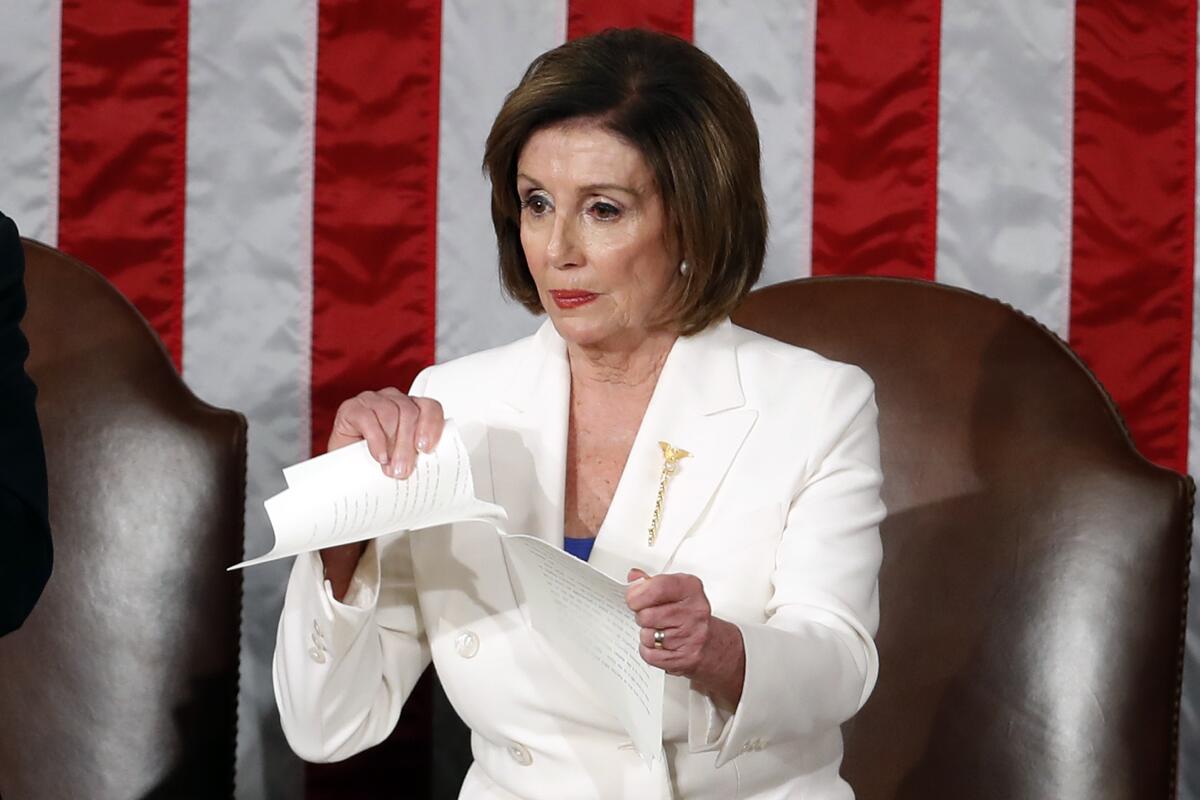 Then-House Speaker Nancy Pelosi of Calif., tears her copy of President Trump's State of the Union address in 2020. 