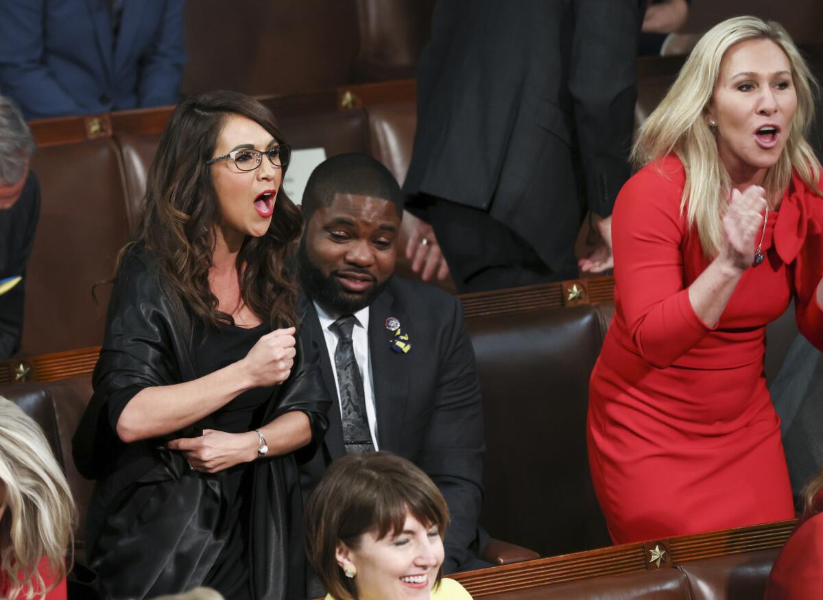 Reps. Lauren Boebert, left, and Marjorie Taylor Greene heckle President Biden as he addresses Congress in 2022. 