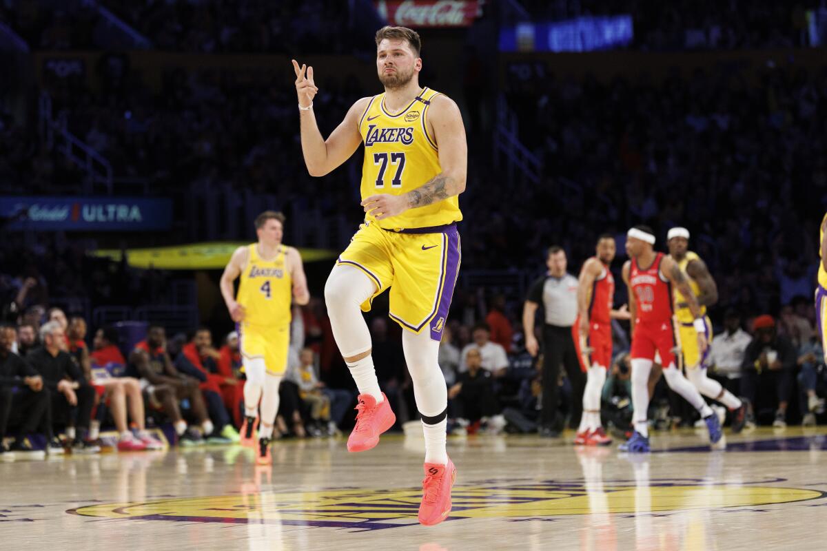 Luka Doncic skips down the court after making a three-point shot against New Orleans in the first half.