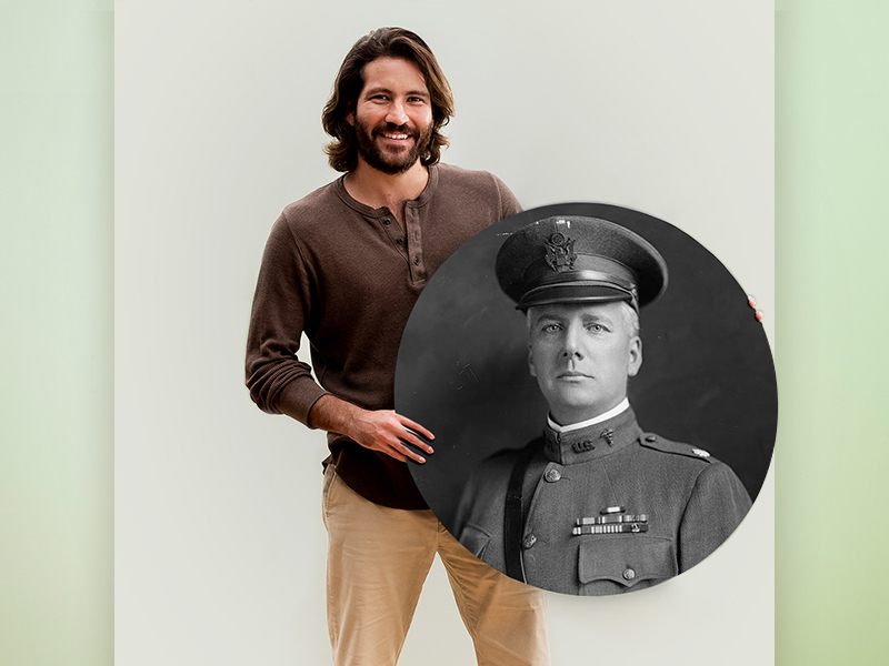 Man holding a large, round, black-and-white photo of a man in a military uniform.