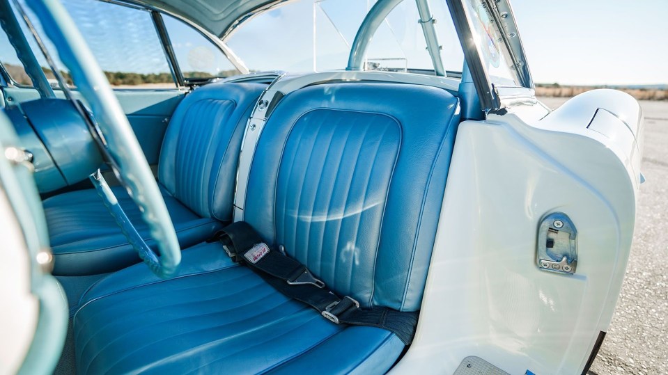 Close-up of a restored 1960 Chevrolet Corvette's blue leather interior.