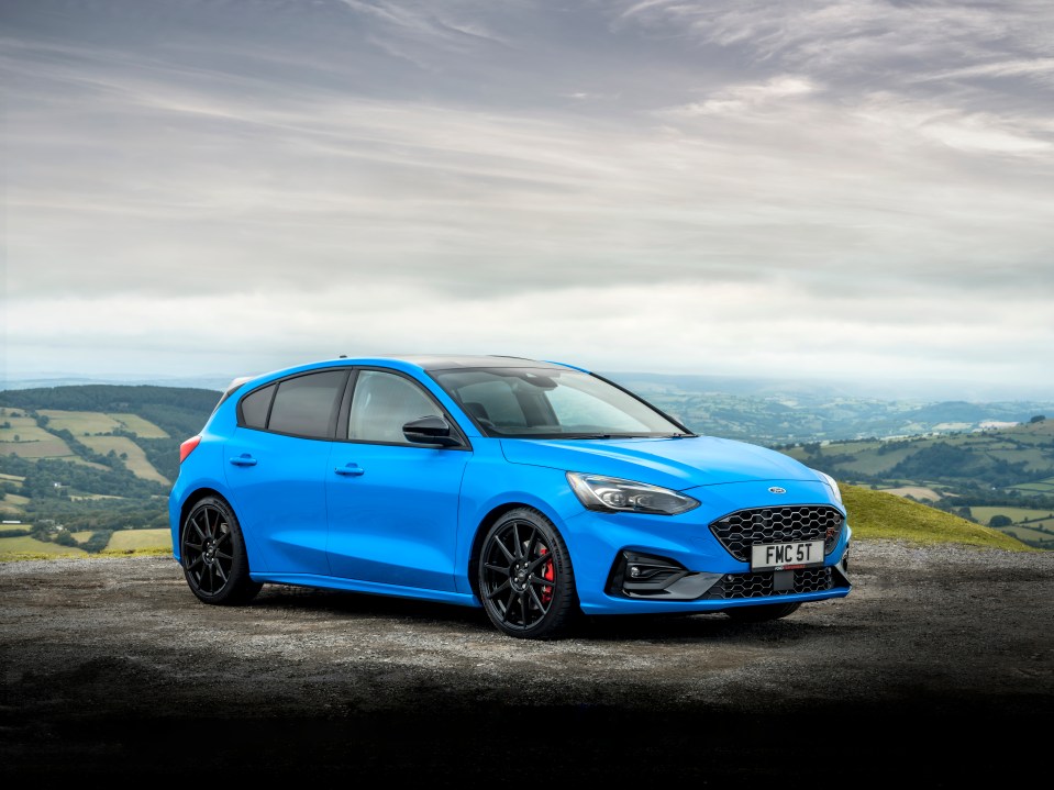 Blue Ford Focus ST Edition parked on a hilltop.