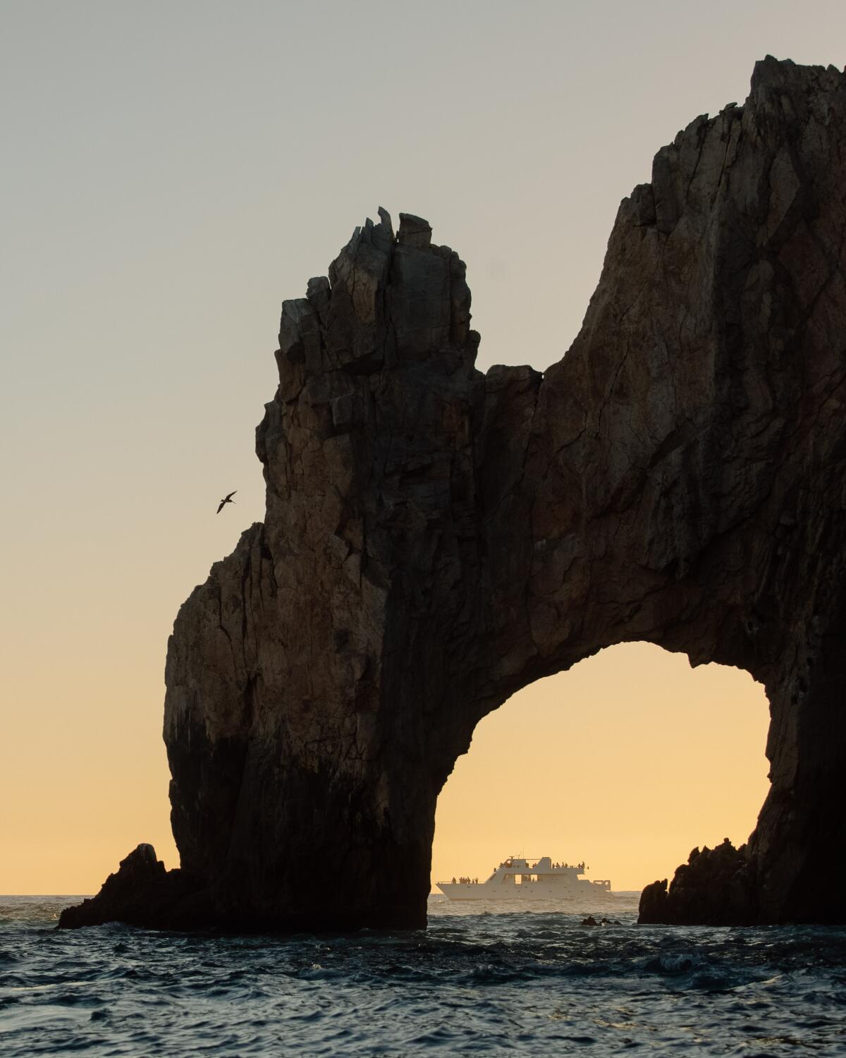 Lands' End: A boat is framed by the Arch of Cabo San Lucas, a granitic rock formation at the southern end of Cabo San Lucas.