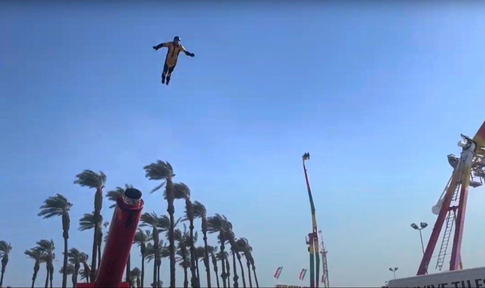 Stuntman flying through the air during a human cannonball act.