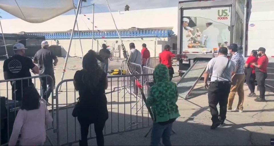 Spectators at a fair watch a human cannonball stunt.