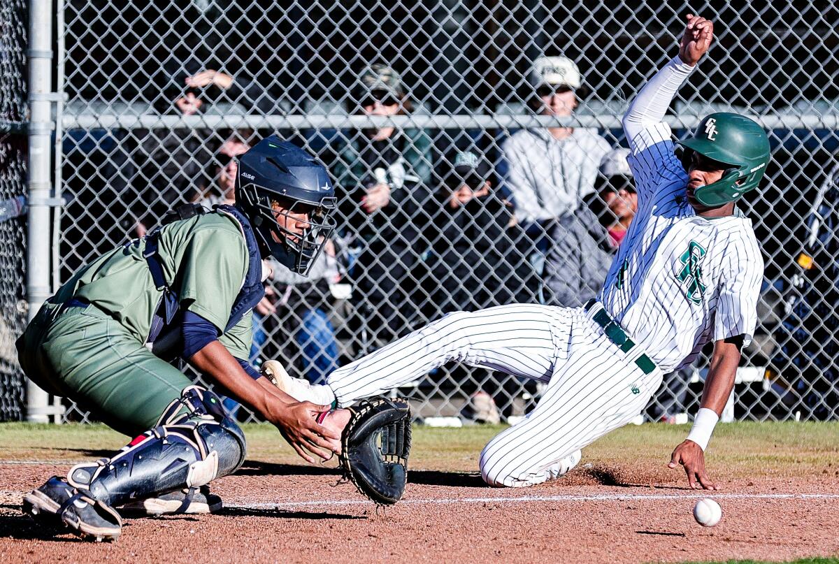 Assane Diaw scores first run for Granada Hills as catcher Jordan Lindsay of Birmingham awaits throw.