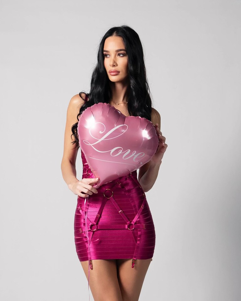 Woman in pink dress holding heart-shaped balloon that says "Love".