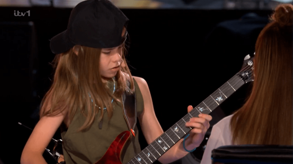 Girl playing electric guitar.