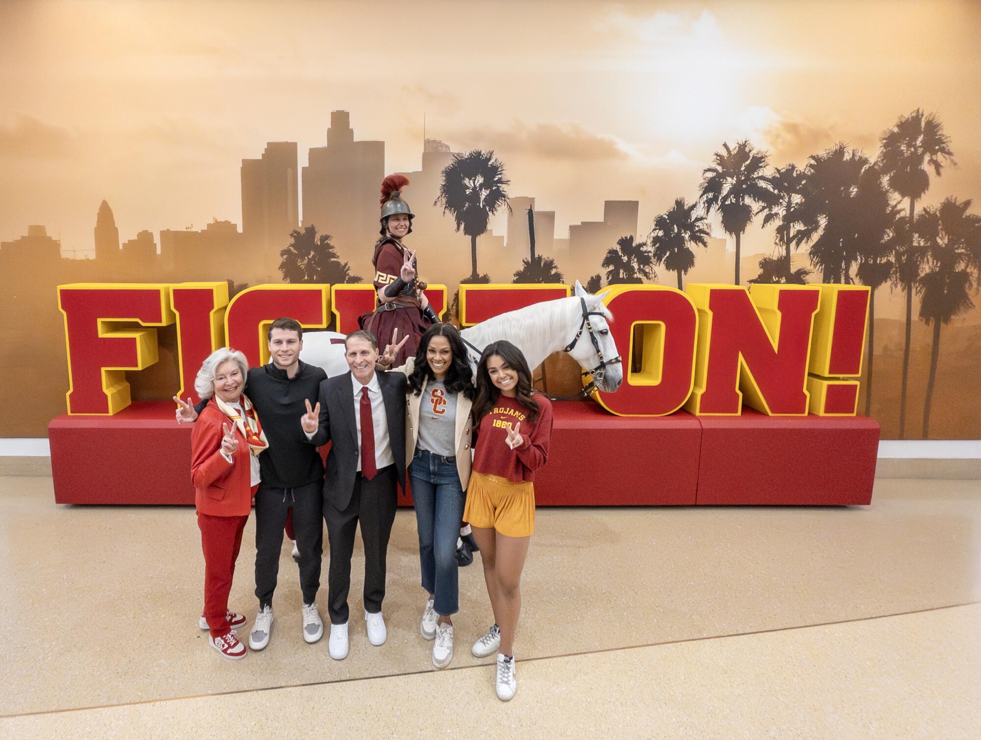 Eric Musselman poses for a photo with his family and USC mascot Traveler 