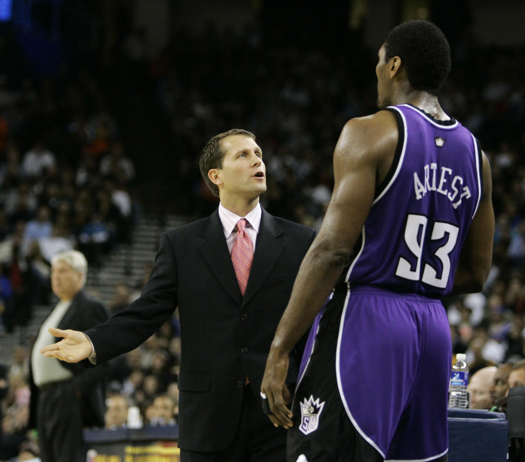 Sacramento Kings coach Eric Musselman talks to Ron Artest during a game against the Golden State Warriors in 2006. 