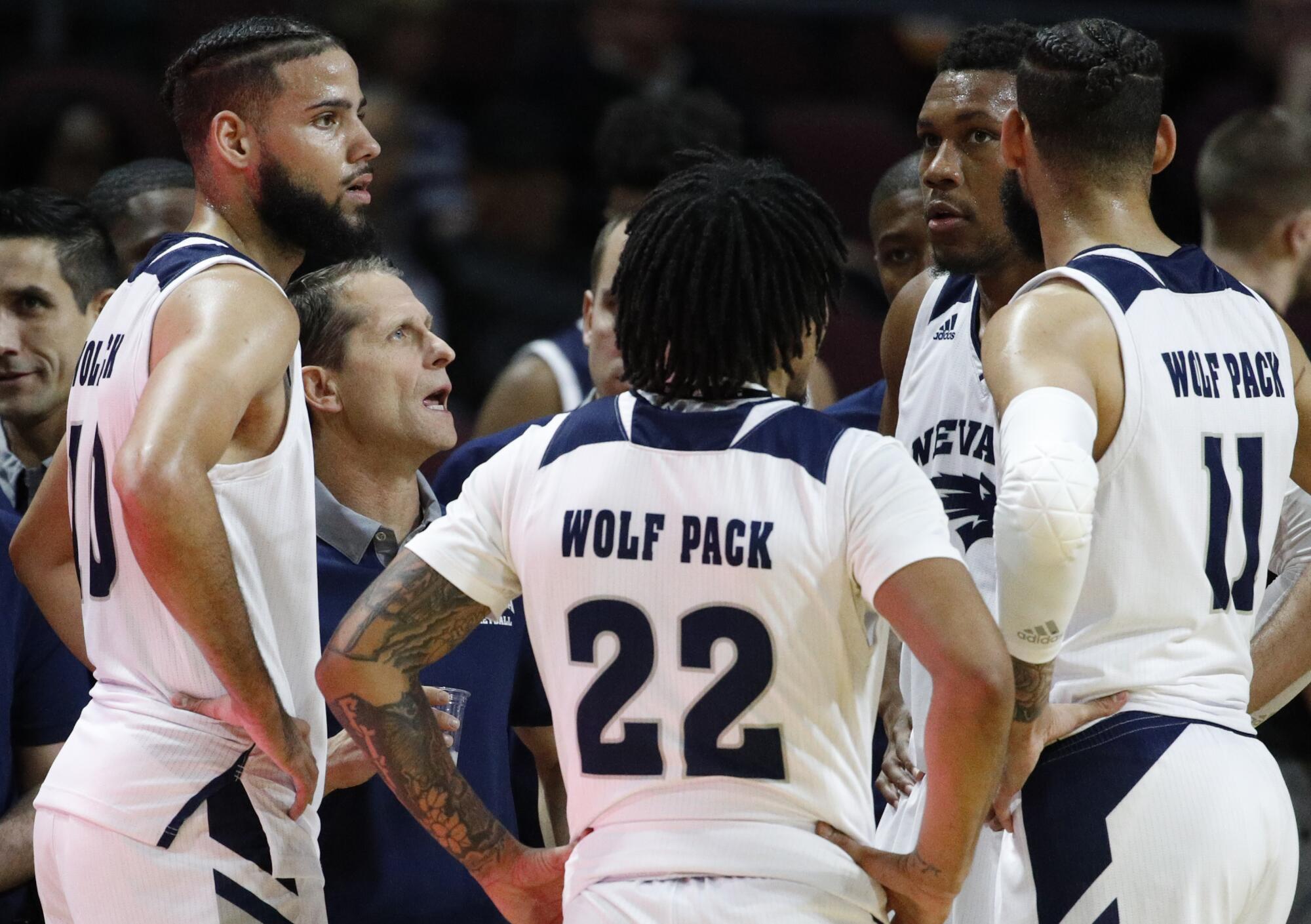 Nevada coach Eric Musselman speaks with his players during a game against Tulsa on Nov. 22, 2018.