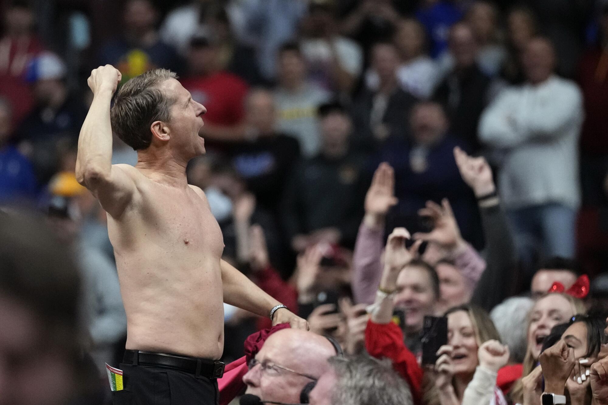 Arkansas coach Eric Musselman celebrates with fans after a second-round NCAA tournament game March 18, 2023.