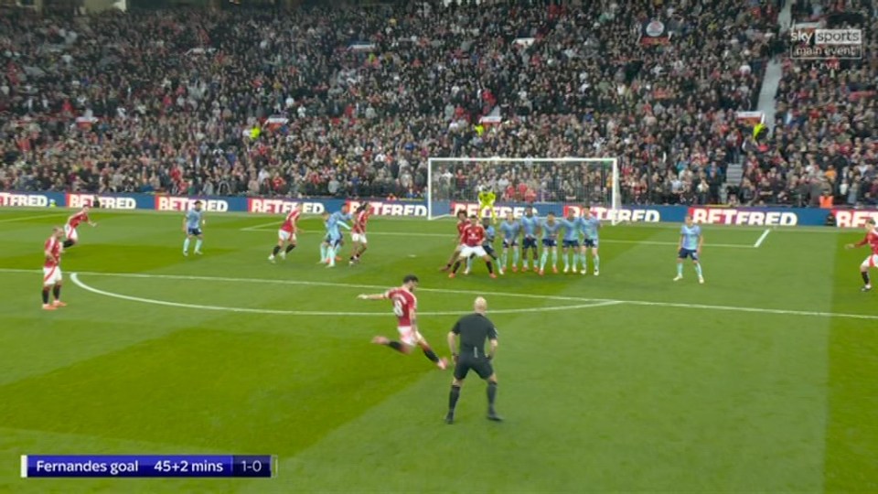 Fernandes taking a free kick during a soccer game.